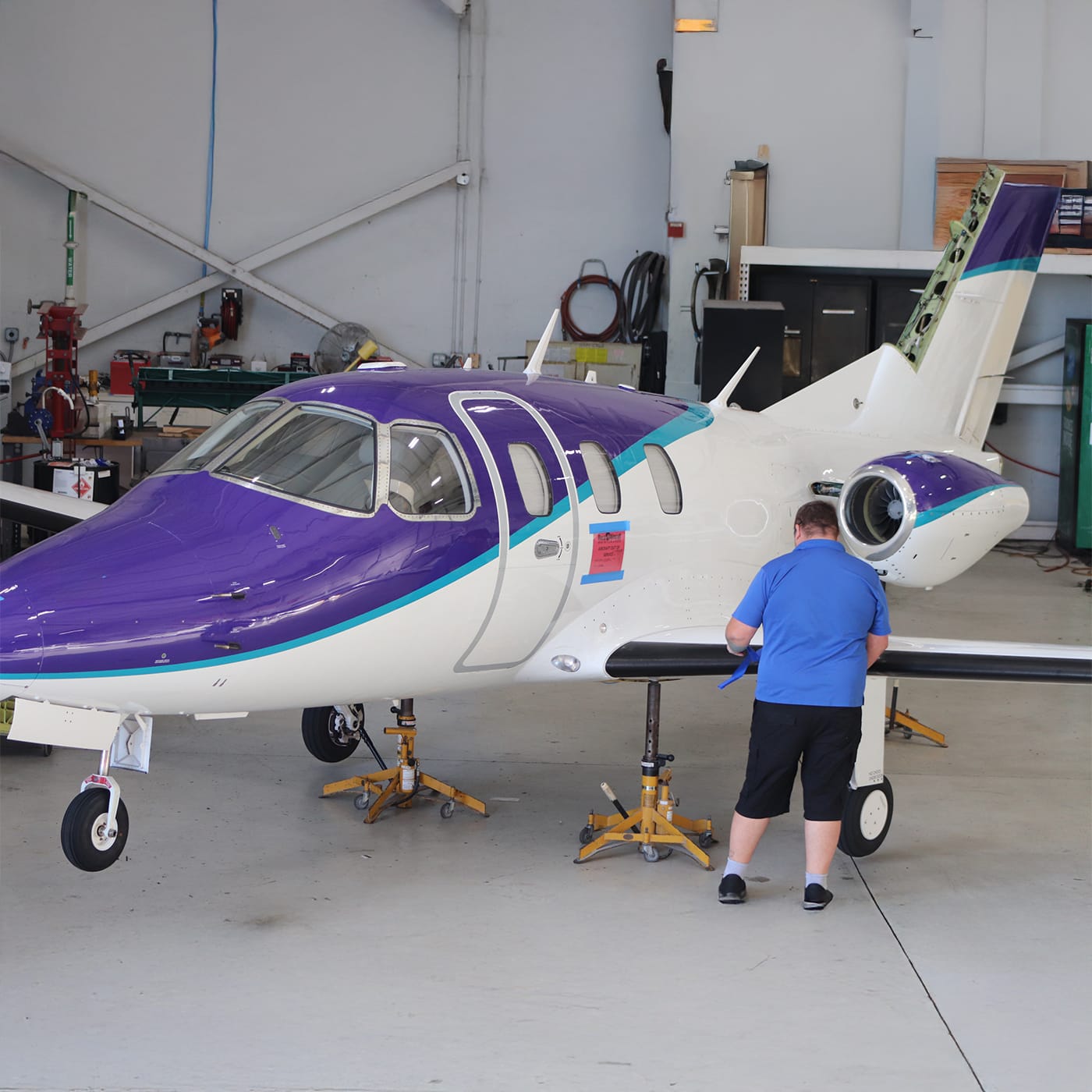 Eclipse aircraft with employee working on wing