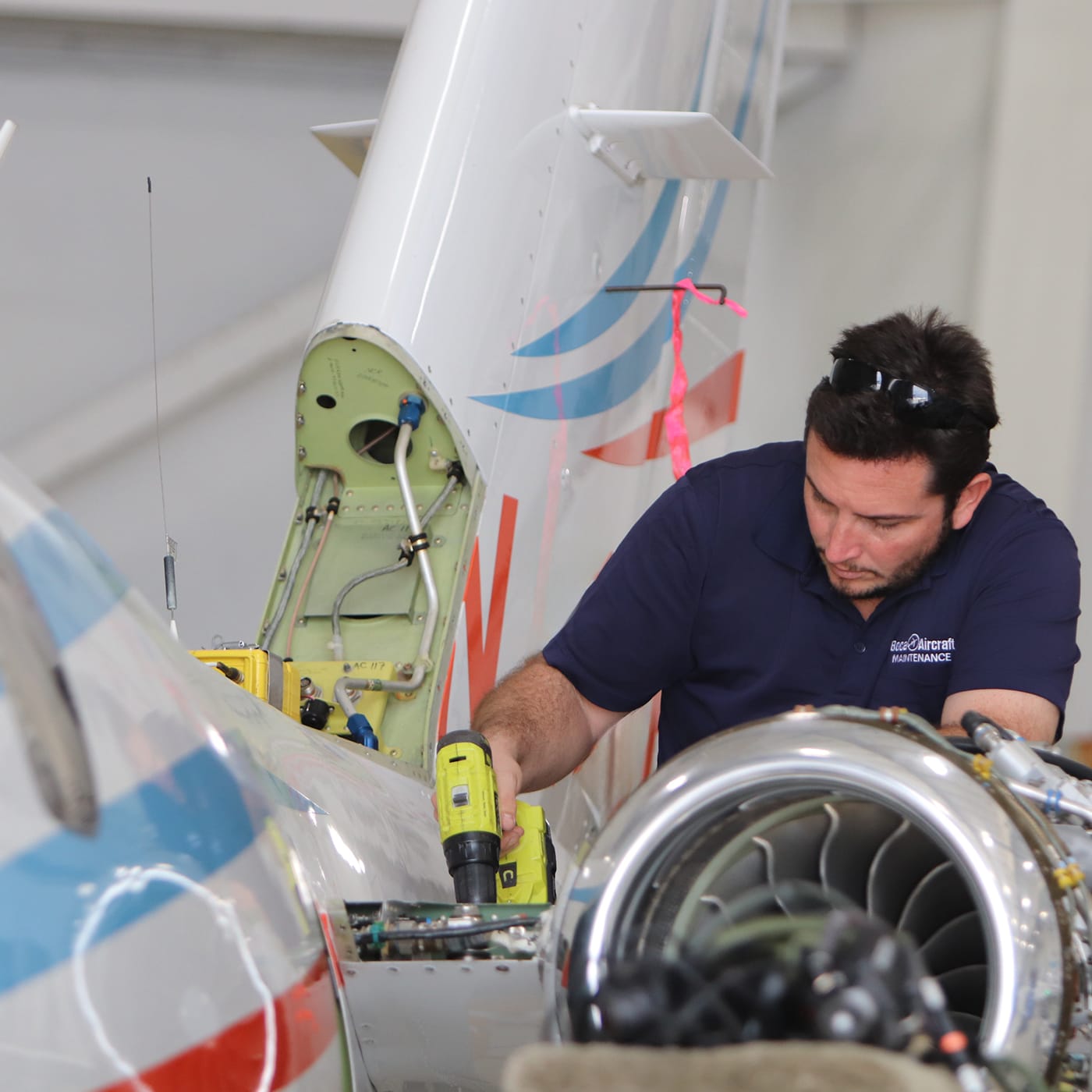 Eclipse aircraft being serviced by technician front