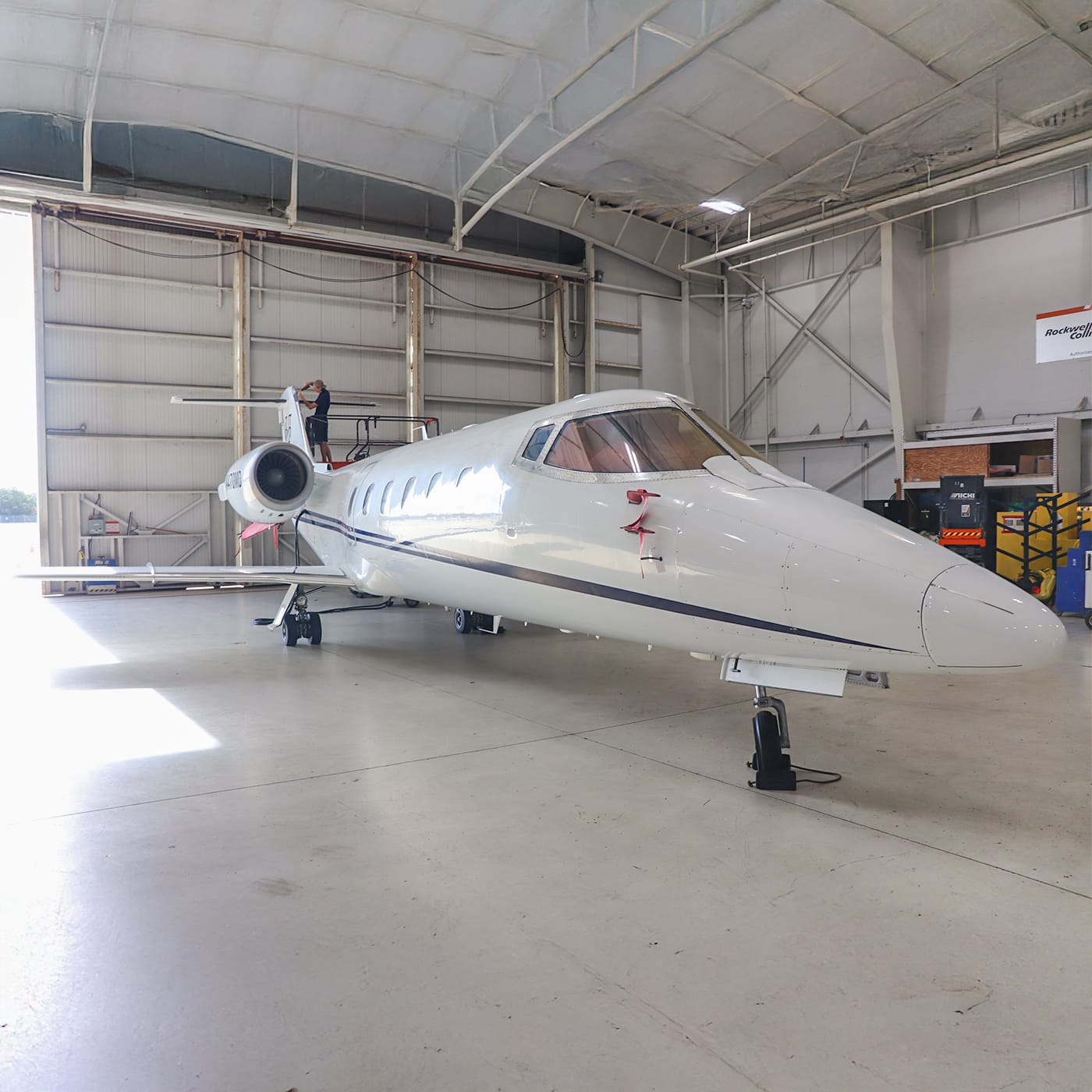 Learjet aircraft being serviced by technician front
