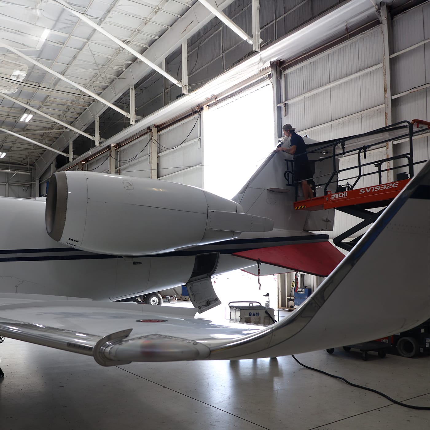 Learjet aircraft being serviced by technician
