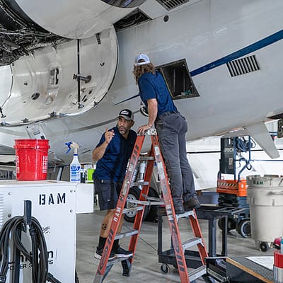 Mechanics working on Falcon jet