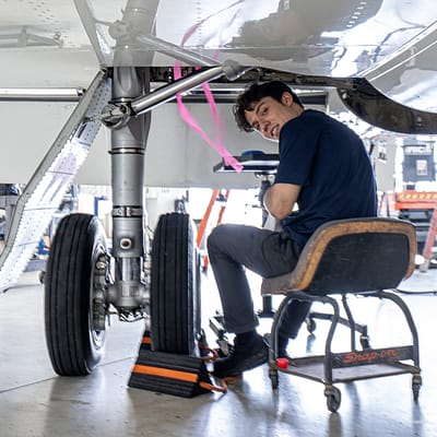 Falcon jet being worked on by mechanic